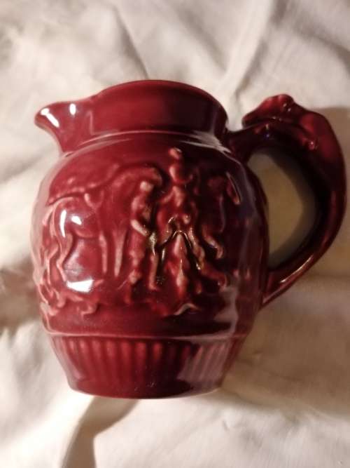 Lucia ware small Burgundy jug... 11cm  tall