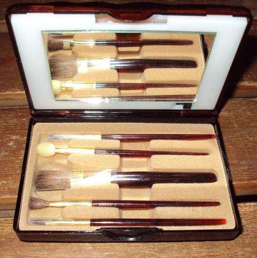 Cosmetic Brushes and Mirror in a Plastic Holder