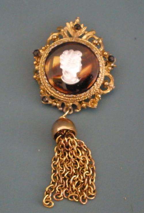 Lovely gold tone cameo brooch with tassels