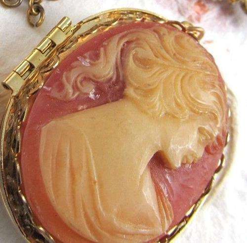 Beautiful gold tone locket pendant with a resin cameo lady portrait in center