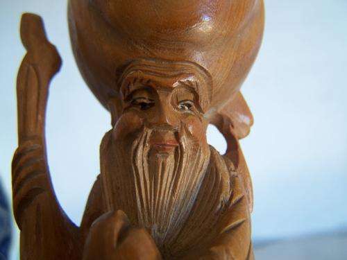 Carved wooden Oriental figurine
