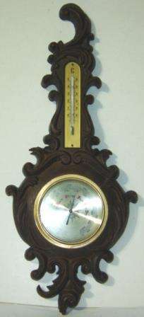 Wall Barometer with Thermometer mounted on a fancy compound frame.