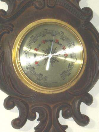 Wall Barometer with Thermometer mounted on a fancy compound frame.