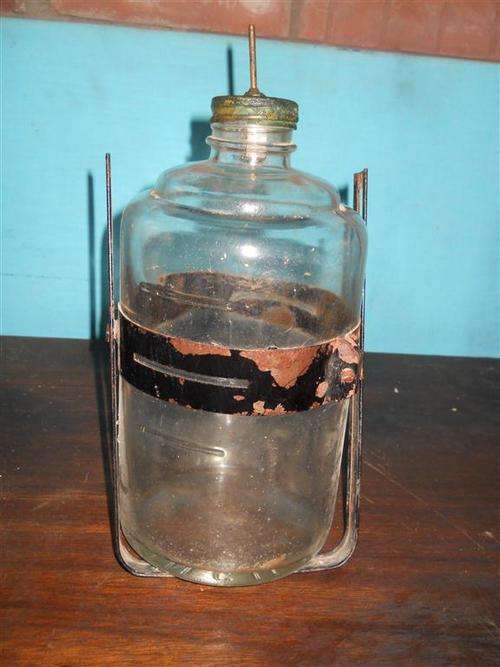 Glass paraffin bottle for antique stove