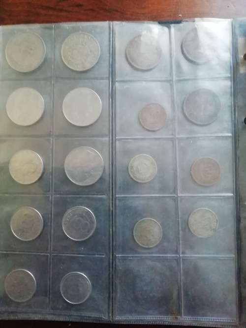 Bickels Coin Album with sleeves and 58 mixed coins.