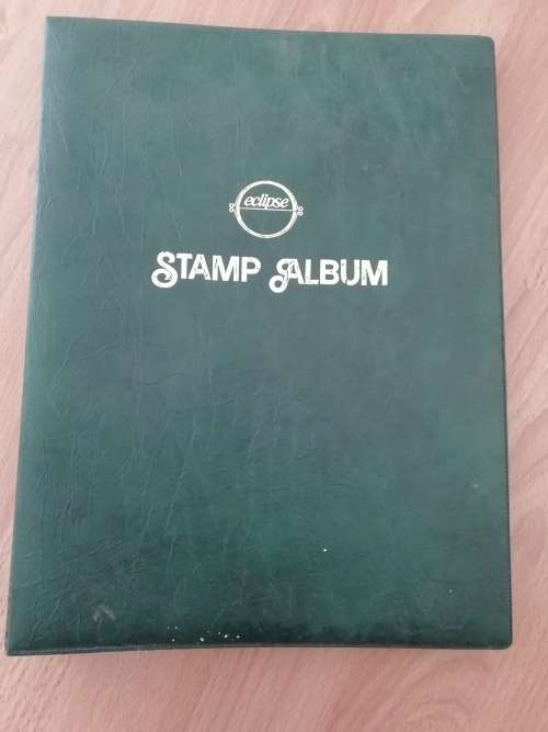 Stamp album, full of hinged stamps.