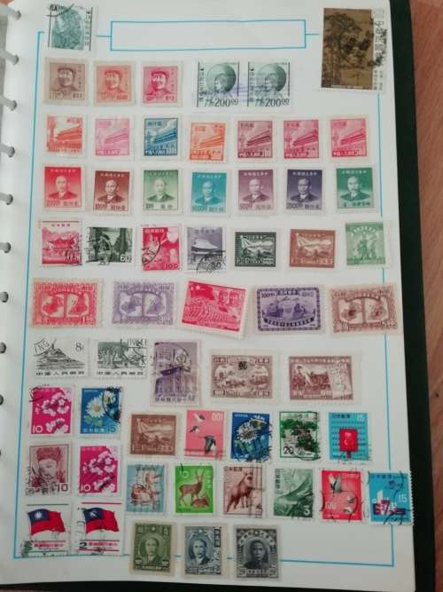 Stamp album, full of hinged stamps.