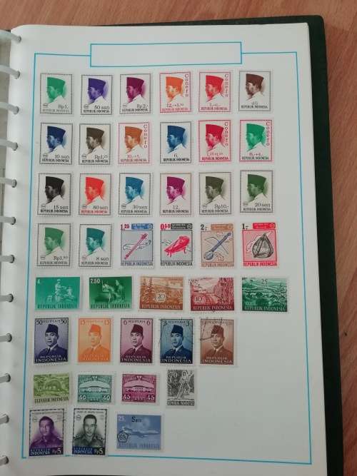 Stamp album, full of hinged stamps.