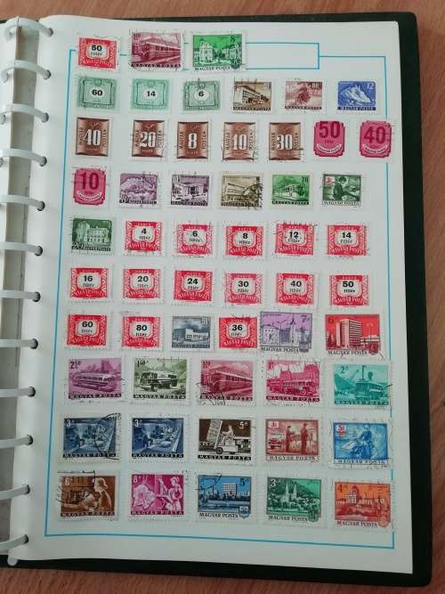 Stamp album, full of hinged stamps.
