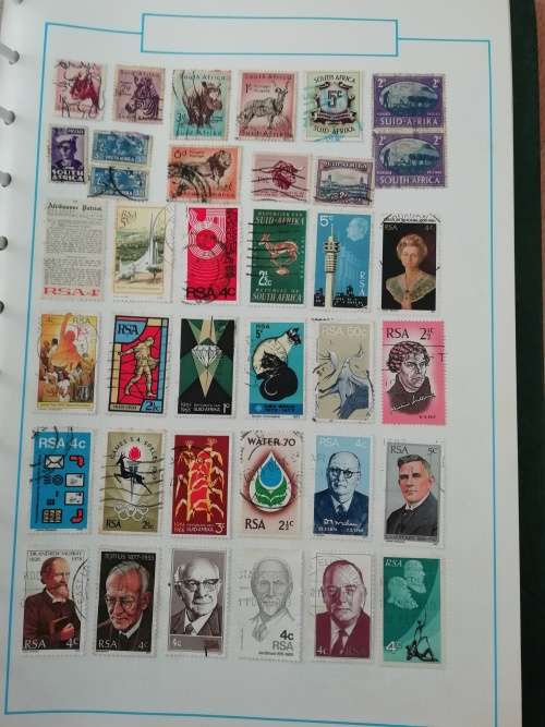 Stamp album, full of hinged stamps.