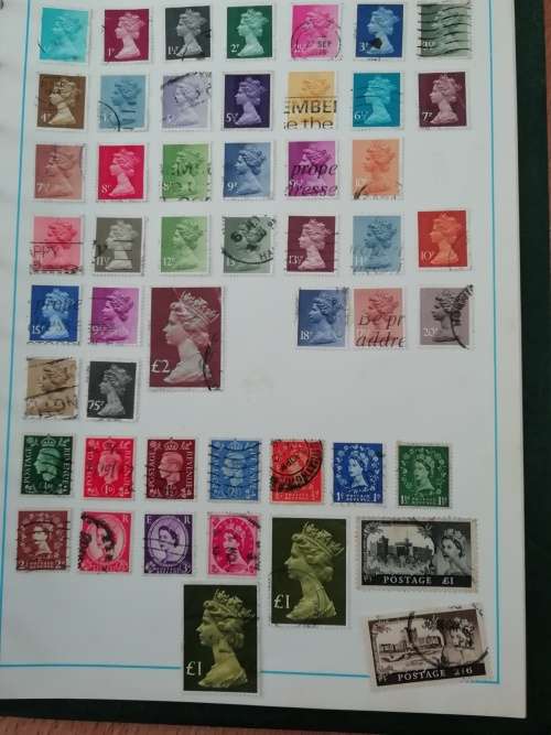 Stamp album, full of hinged stamps.