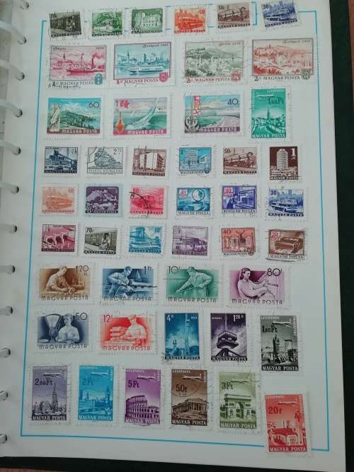 Stamp album, full of hinged stamps.