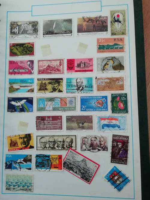 Stamp album, full of hinged stamps.