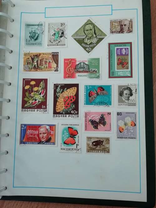 Stamp album, full of hinged stamps.