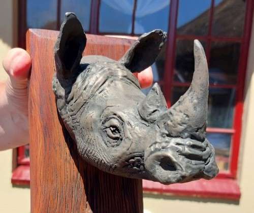 WHITE RHINO HENKMAM CLAY SCULPTURE WITH BRONZE COATING ON WOODEN WALL MOUNT