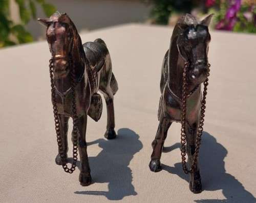 PAIR OF BRONZE OR COPPER COWBOY STYLE HORSES WITH BEADED CHAIN RAINS AND MOLDED SADDLES