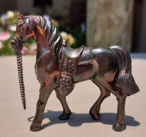 PAIR OF BRONZE OR COPPER COWBOY STYLE HORSES WITH BEADED CHAIN RAINS AND MOLDED SADDLES
