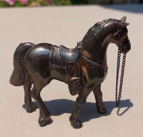PAIR OF BRONZE OR COPPER COWBOY STYLE HORSES WITH BEADED CHAIN RAINS AND MOLDED SADDLES