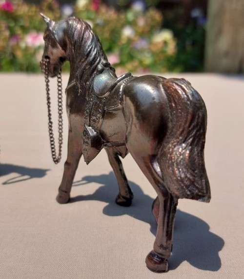 PAIR OF BRONZE OR COPPER COWBOY STYLE HORSES WITH BEADED CHAIN RAINS AND MOLDED SADDLES