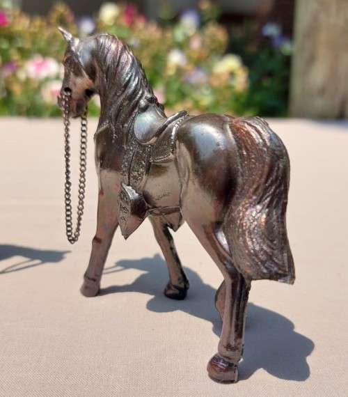 PAIR OF BRONZE OR COPPER COWBOY STYLE HORSES WITH BEADED CHAIN RAINS AND MOLDED SADDLES