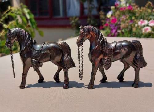 PAIR OF BRONZE OR COPPER COWBOY STYLE HORSES WITH BEADED CHAIN RAINS AND MOLDED SADDLES