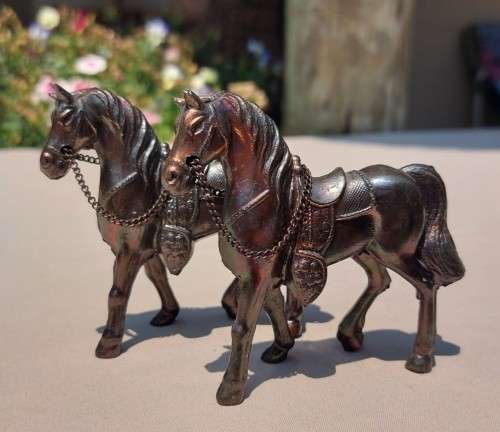 PAIR OF BRONZE OR COPPER COWBOY STYLE HORSES WITH BEADED CHAIN RAINS AND MOLDED SADDLES