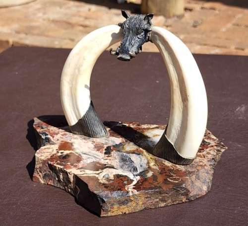 STRIKING WARTHOG TUSKS MOUNTED POCKET WATCH STAND WITH POSSIBLE SILVER MASQUE (WATCH NOT INCLUDED)