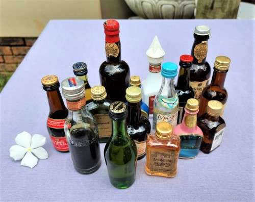 COLLECTION OF SIXTEEN (16) MINIATURE LIQUOR BOTTLES (MOST ARE FULL, SOME 75% FULL)