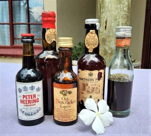 COLLECTION OF SIXTEEN (16) MINIATURE LIQUOR BOTTLES (MOST ARE FULL, SOME 75% FULL)