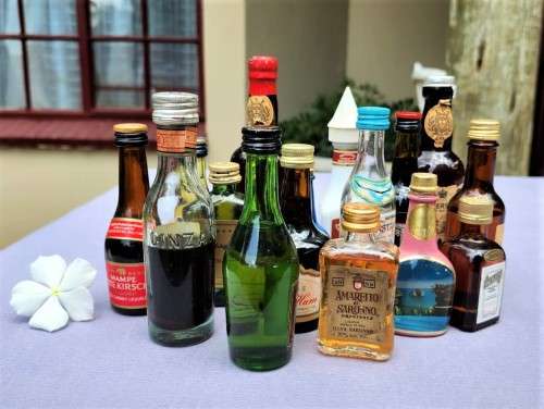 COLLECTION OF SIXTEEN (16) MINIATURE LIQUOR BOTTLES (MOST ARE FULL, SOME 75% FULL)
