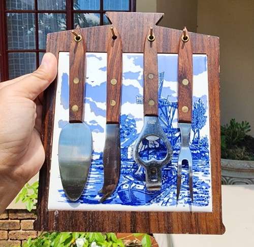 A DUTCH CERAMIC PLATE UTENSIL HOLDER WITH PRONGED CHEESE KNIFE AND SKEWER
