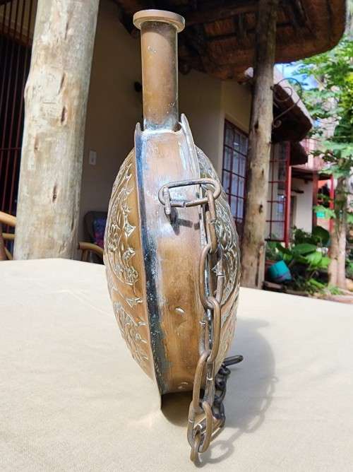 A VINTAGE ISLAMIC BRASS GUN POWDER FLASK