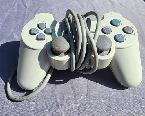 A MIGHTY PS ONE BUNDLE WORKING: CONSOLE WITH DUAL SHOCK CONTROLLER, MEMORY CARD AND TWO GAMES