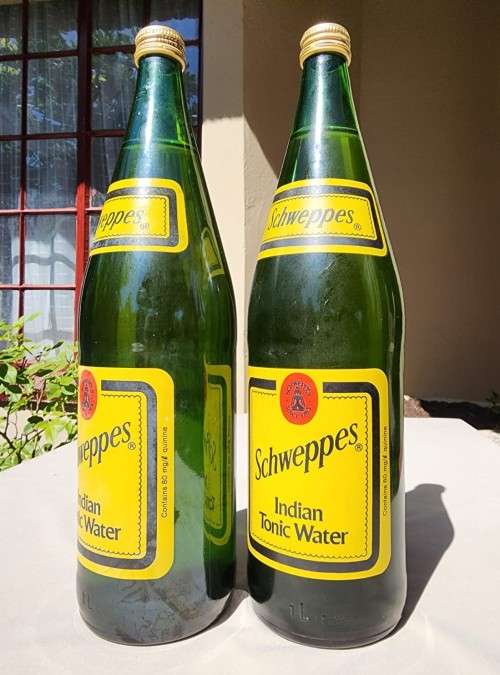 FIGHTING MALARIA WITH TWO FULL VINTAGE GLASS BOTTLES OF SCHWEPPES INDIAN TONIC WATER