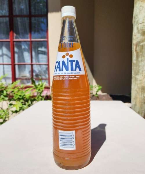 VINTAGE 1970S-1980S RIBBED FANTA 1L GLASS BOTTLE STILL FULL AND UNOPENED LABELS IN ENG AND AFR