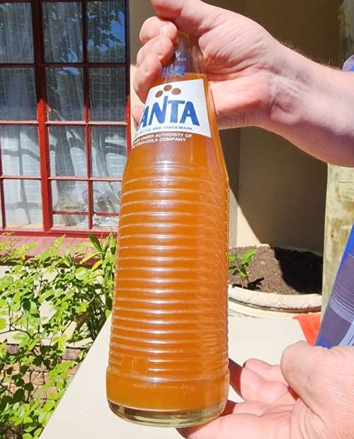 VINTAGE 1970S-1980S RIBBED FANTA 1L GLASS BOTTLE STILL FULL AND UNOPENED LABELS IN ENG AND AFR