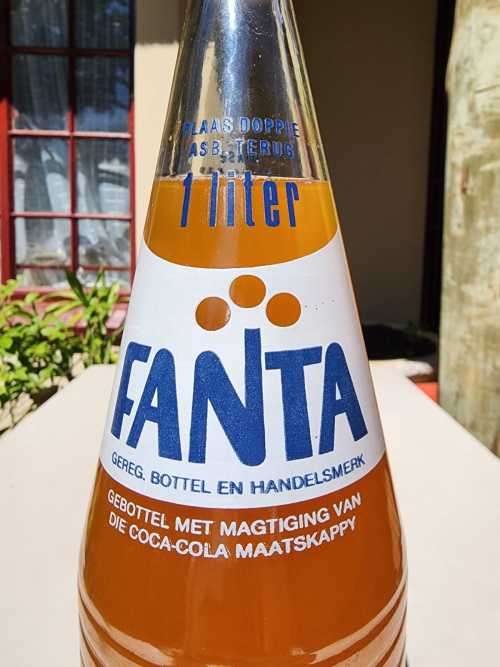 VINTAGE 1970S-1980S RIBBED FANTA 1L GLASS BOTTLE STILL FULL AND UNOPENED LABELS IN ENG AND AFR