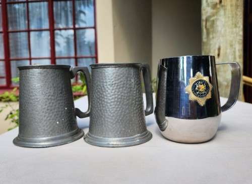 TWO EXCALUBUR SA UNION (PRE 1961) PEWTER TANKARDS AND A SA POLICE (PRE 1994) ATLANTA STAINLESS STEEL