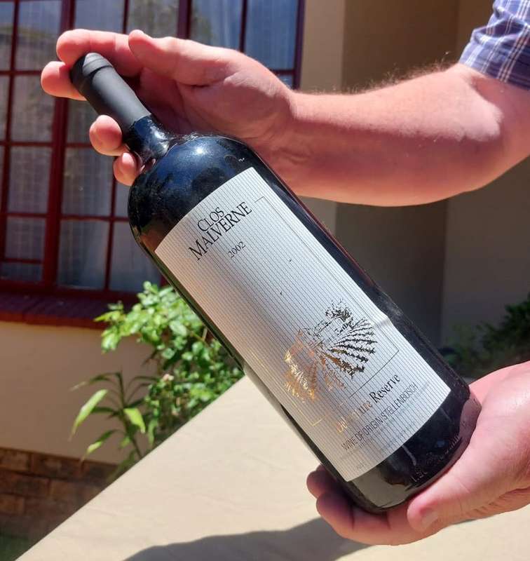 A 2002 CLOS MALVERNE 1,5L DEBENTURE RESERVE IN WOODEN CRATE  A UNIQUE BLEND OF PINOTAGE AND MERLOT