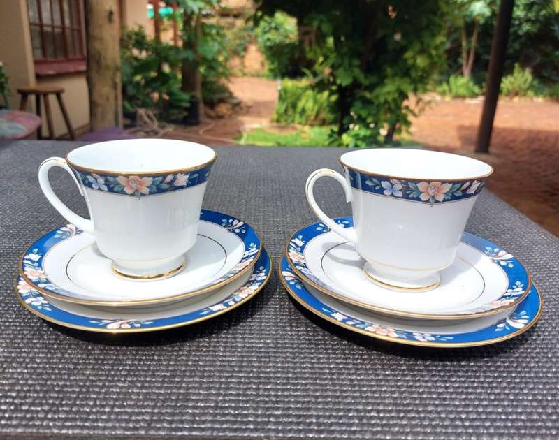 TWO HAND DECORATED NORITAKE SRI LANKA TRIOS (TEACUP, SAUCER, SIDEPLATE) CIRCA 1988-1996.