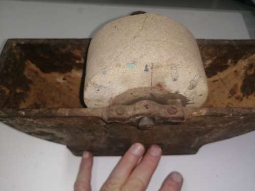 Grinding stone in cast iron holder with handle - very old and with some damage