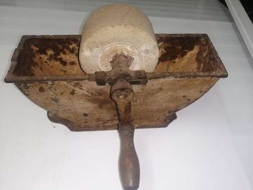 Grinding stone in cast iron holder with handle - very old and with some damage