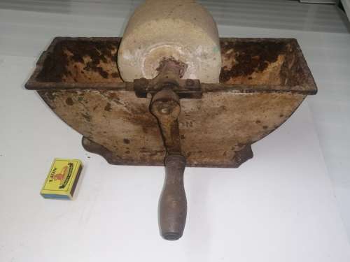 Grinding stone in cast iron holder with handle - very old and with some damage