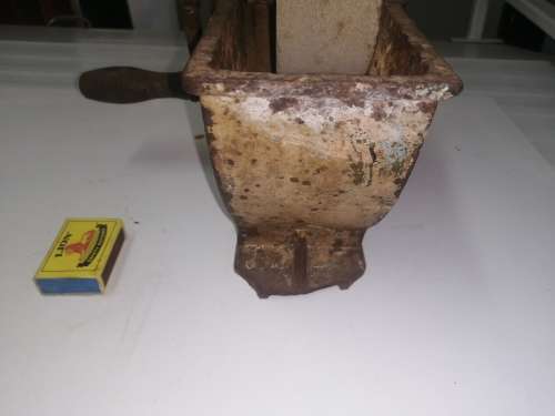 Grinding stone in cast iron holder with handle - very old and with some damage