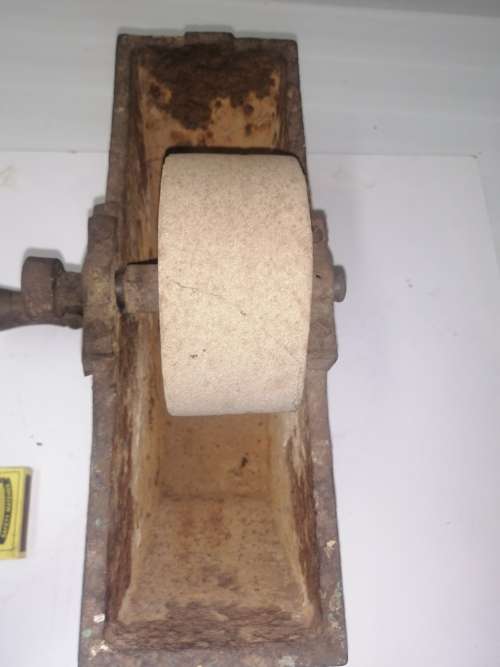 Grinding stone in cast iron holder with handle - very old and with some damage