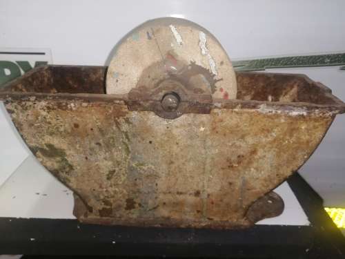 Grinding stone in cast iron holder with handle - very old and with some damage