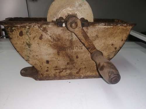 Grinding stone in cast iron holder with handle - very old and with some damage