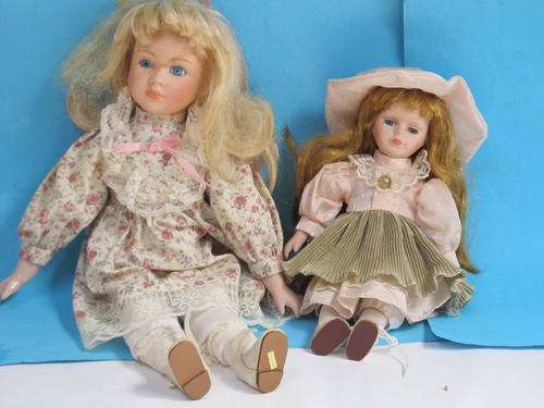 PAIR OF PORCELAIN DOLLS