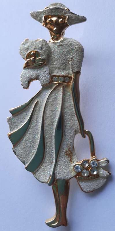Elegant  woman with a dog and bag brooch