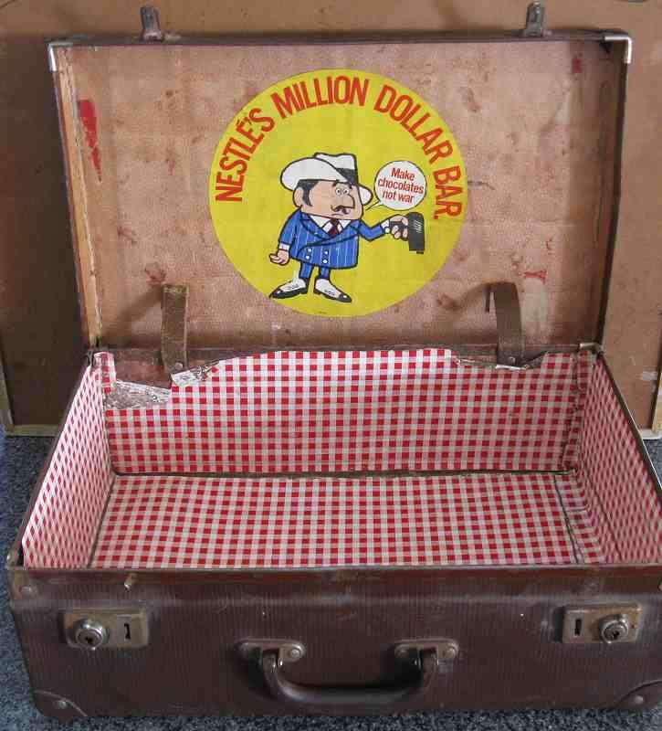 VINTAGE SUITCASE WITH A NESTLE MILLION DOLLAR BAR "MAKE CHOCOLATE NOT WAR" STICKER ON INNER.